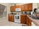 Well-equipped kitchen featuring wood cabinets and appliances at 4527 Alberto Cir, Kissimmee, FL 34746