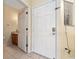 Front entry with white door and adjacent half bathroom at 4527 Alberto Cir, Kissimmee, FL 34746