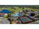 Aerial view showing pools, tennis courts, playground, and homes at 2132 Antilles Club Dr, Kissimmee, FL 34747