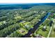 Aerial view showcasing waterfront homes and lush green landscape at 3911 Gardenia Dr, Indian Lake Estates, FL 33855