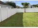 Spacious backyard with a white vinyl fence and grassy lawn at 514 Tree Shore Dr, Orlando, FL 32825