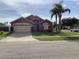 Two-story house with a two-car garage and manicured lawn at 514 Tree Shore Dr, Orlando, FL 32825