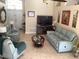 Spacious living room featuring two comfy sofas and a large TV at 514 Tree Shore Dr, Orlando, FL 32825