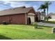 Red house with a two car garage and green lawn at 514 Tree Shore Dr, Orlando, FL 32825