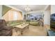 Living room with green sectional sofa and granite floor at 2531 Lyndscape St, Orlando, FL 32833
