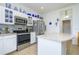 Updated kitchen with stainless steel appliances and an island at 2531 Lyndscape St, Orlando, FL 32833