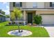 Landscaped front yard with a palm tree and stone accents at 2531 Lyndscape St, Orlando, FL 32833