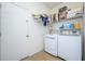 Laundry room with washer, dryer, and storage shelves at 2531 Lyndscape St, Orlando, FL 32833