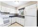 Clean kitchen featuring white appliances and tile floors at 115 Springwood Cir # C, Longwood, FL 32750