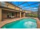 Relaxing pool and spa with seating area under covered patio at 8810 Macapa Dr, Kissimmee, FL 34747