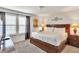 Spacious bedroom with a king-size bed, two windows, and ample lighting at 8810 Macapa Dr, Kissimmee, FL 34747