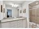 Double vanity bathroom with granite countertop and shower at 8810 Macapa Dr, Kissimmee, FL 34747