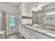 Double vanity bathroom with granite countertop and walk-in shower at 8810 Macapa Dr, Kissimmee, FL 34747