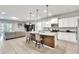 Modern kitchen with island, granite countertops, and white cabinets at 8810 Macapa Dr, Kissimmee, FL 34747