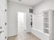 Functional laundry room with washer, dryer, and built-in shelving at 8810 Macapa Dr, Kissimmee, FL 34747