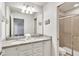 Bathroom with double vanity, granite countertop, and shower at 8810 Macapa Dr, Kissimmee, FL 34747