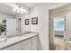 Bathroom with single vanity, granite countertop, and access to bedroom at 8810 Macapa Dr, Kissimmee, FL 34747