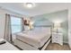 Bedroom with a queen bed, and light green accent wall at 8810 Macapa Dr, Kissimmee, FL 34747