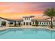 Inviting community pool with lounge chairs and sunset view at 8810 Macapa Dr, Kissimmee, FL 34747