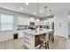 Modern kitchen with island, granite countertops, and white cabinets at 8810 Macapa Dr, Kissimmee, FL 34747