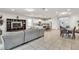 Open living and dining space with a sectional sofa and tile floor at 8810 Macapa Dr, Kissimmee, FL 34747