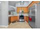 Well-equipped kitchen with stainless steel appliances and light wood cabinets at 2635 Quarterdeck Ct, Kissimmee, FL 34743