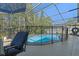 Inviting screened pool with safety fence and patio furniture at 2635 Quarterdeck Ct, Kissimmee, FL 34743