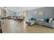 Spacious living room with sectional sofa, tile floors, and access to the dining area at 2635 Quarterdeck Ct, Kissimmee, FL 34743