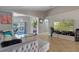 Open living area with sectional sofa, tile floors, and view of the pool at 2635 Quarterdeck Ct, Kissimmee, FL 34743
