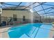 Refreshing screened pool with safety fence and patio furniture at 2635 Quarterdeck Ct, Kissimmee, FL 34743