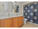 Charming bathroom with double sinks and a daisy shower curtain at 2635 Quarterdeck Ct, Kissimmee, FL 34743