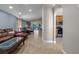 Spacious living room with leather sofa and view into dining area at 2635 Quarterdeck Ct, Kissimmee, FL 34743