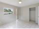 Bedroom with tile floors, window, and closet at 6809 Ambassador Dr, Orlando, FL 32818