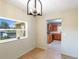Dining area with kitchen and window views, light walls, and wood-look floors at 6809 Ambassador Dr, Orlando, FL 32818