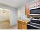 Modern kitchen with wood cabinets and stainless steel appliances at 6809 Ambassador Dr, Orlando, FL 32818