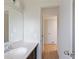 Updated bathroom with single vanity, mirror, and access to hallway at 6809 Ambassador Dr, Orlando, FL 32818