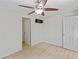 Spacious bedroom with ceiling fan, wood-look floors, and ample wall space at 6809 Ambassador Dr, Orlando, FL 32818