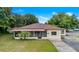 Front view of charming ranch home with mature landscaping at 1404 E Alfred St, Tavares, FL 32778