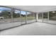 Spacious sunroom with multiple windows and grey flooring at 1404 E Alfred St, Tavares, FL 32778