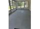 Spacious sunroom with multiple windows and grey flooring at 1404 E Alfred St, Tavares, FL 32778