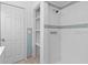 Bathroom with shower, built-in shelving and tile at 1404 E Alfred St, Tavares, FL 32778