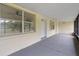 Bright, covered front porch with screened enclosure at 1404 E Alfred St, Tavares, FL 32778