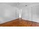 Bedroom with hardwood floors, double door closet and ceiling fan at 1404 E Alfred St, Tavares, FL 32778