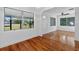 Bright dining room with hardwood floors and large windows at 1404 E Alfred St, Tavares, FL 32778