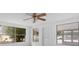 Living room with large windows, ceiling fan, and hardwood floors at 1404 E Alfred St, Tavares, FL 32778