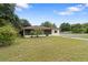 House with a large front yard and street view at 1404 E Alfred St, Tavares, FL 32778