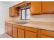 Kitchen features brown cabinets and speckled countertops at 1404 E Alfred St, Tavares, FL 32778