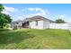 Spacious backyard with grassy area and fenced perimeter at 1712 Lime Dr, Winter Haven, FL 33881