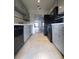 Bright kitchen features gray cabinets, black appliances, and tile flooring at 5329 Hansel Ave # B-4, Edgewood, FL 32809