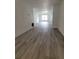 Living room with fireplace and gray laminate wood flooring at 5329 Hansel Ave # B-4, Edgewood, FL 32809